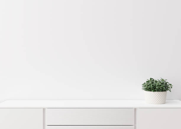 istock Empty white wall. Mock up interior in contemporary style. Close up view. Free space, copy space for your picture, text, or another design. Sideboard, plant. 3D rendering. 1375260253