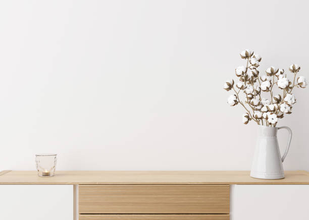 istock Empty white wall. Mock up interior in contemporary style. Close up view. Free space, copy space for your picture, text, or another design. Sideboard, cotton plant. 3D rendering. 1375260257