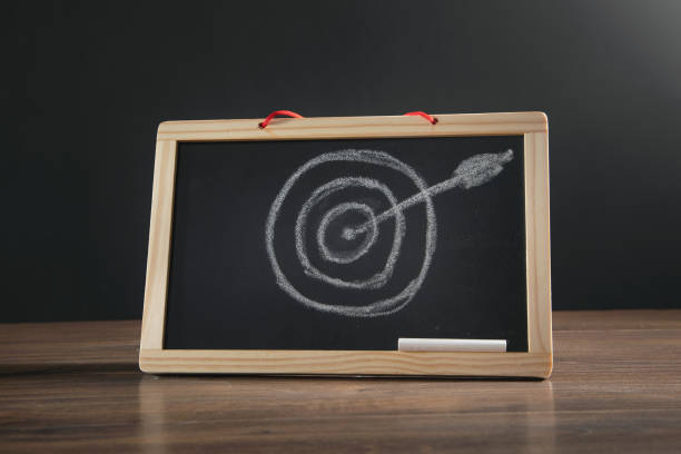 istock Target and arrow on small chalkboard. Goals. Success 1375264767