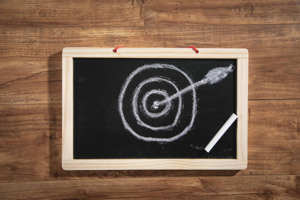 istock Target and arrow on small chalkboard. Goals. Success 1375264769