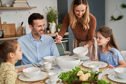 Caucasian family beginning easter dinner at home