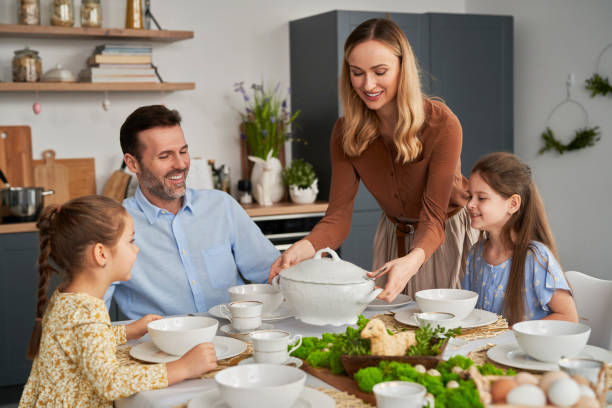 Caucasian family about to start an easter dinner at home stock photo