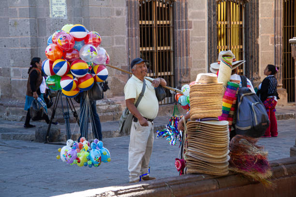 San Cristobal de las Casas, Chiapas/Mexico--April 9, 2010. Two balloon vendors meet and talk in the city's main square.