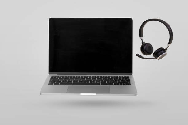 istock Laptop computer with empty screen and headset  levitating in the air on a gray background. Creative minimal background. 1375297152