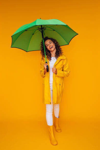 istock Girl with green umbrella 1375301942