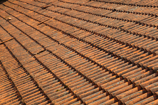 new and old tiles line the roof of the house