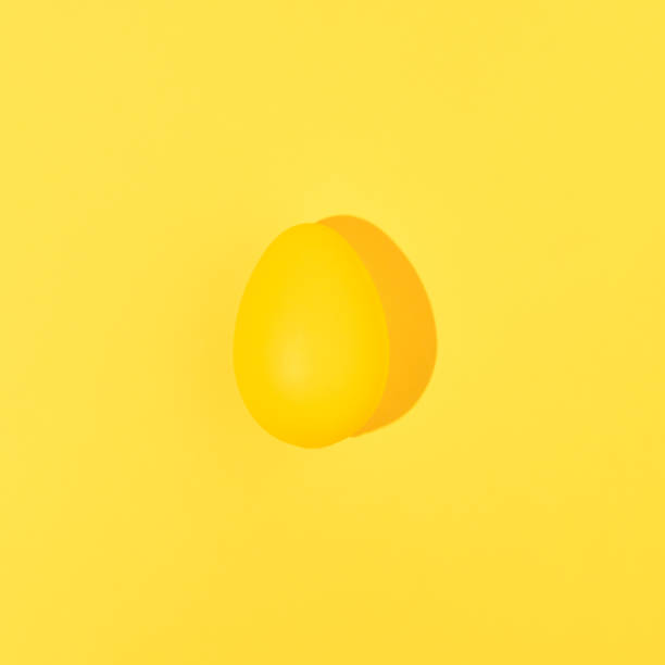 istock Yellow Easter egg isolated on yellow background. Minimal food concept. Monochromatic composition. 1375320130