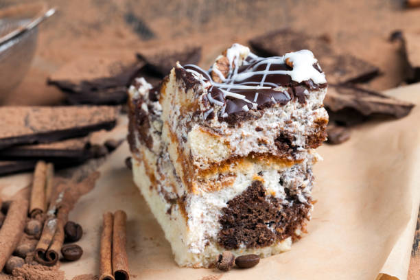 a multi-layered cake made of chocolate and cream cakes in a chaotic order in the cake, lot of chocolate, cinnamon and cocoa powder scattered around the cake