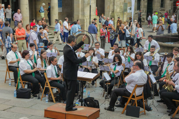 2018 June 23. Spain. Santiago de Compostela. Concert of classical music, on the square near the cathedral. Residents of the city, pilgrims and just tourists watching and enjoying the music.