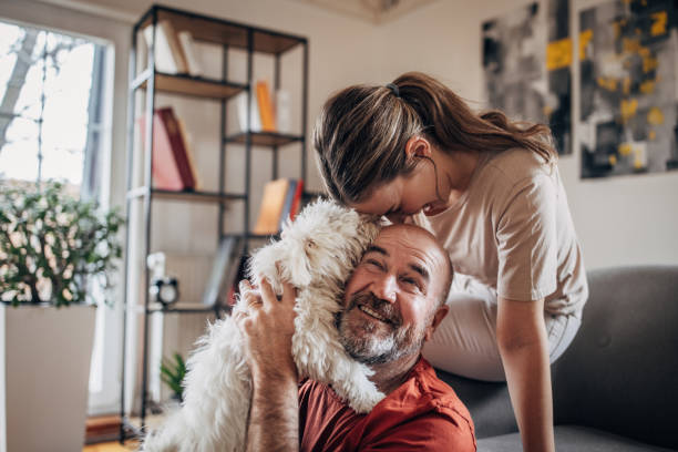 istock Family playing with dog 1375339262