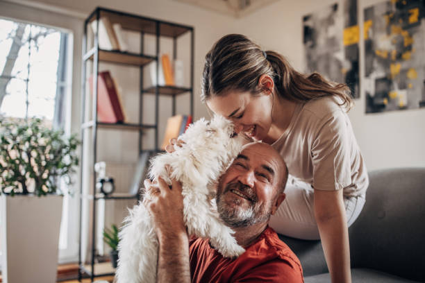 istock Family playing with dog 1375339270