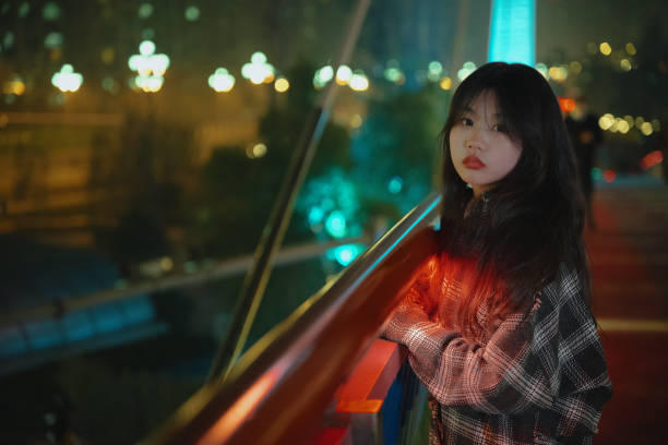 istock Asian young women on the bridge at night 1375341373