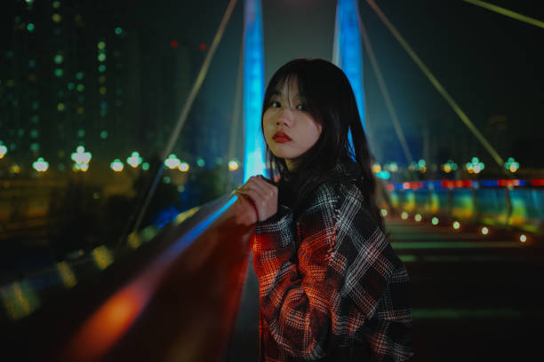 istock Asian young women on the bridge at night 1375341374