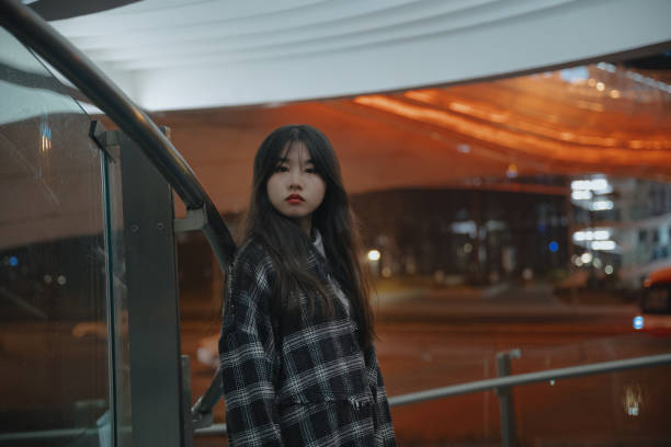 istock Asian young women on the bridge at night 1375341890
