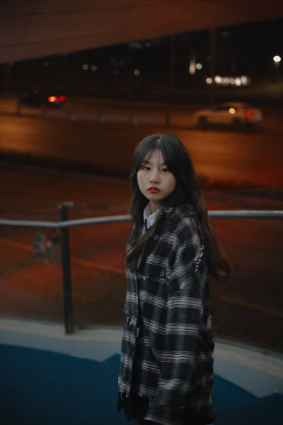 istock Asian young women on the bridge at night 1375342581