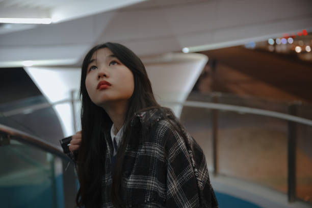 istock Asian young women on the bridge at night 1375343456