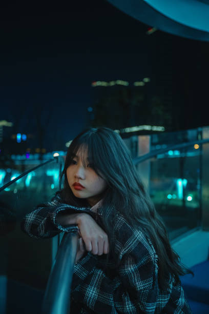 istock Asian young women on the bridge at night 1375343462