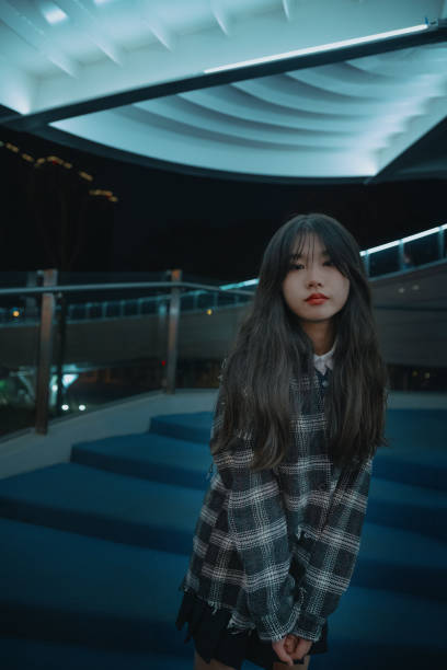 istock Asian young women on the bridge at night 1375344505