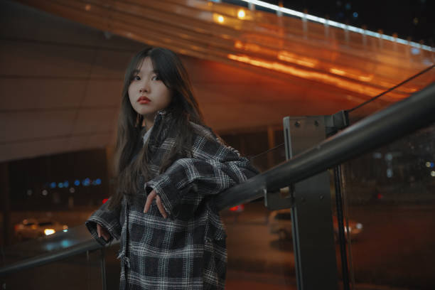 istock Asian young women on the bridge at night 1375345415