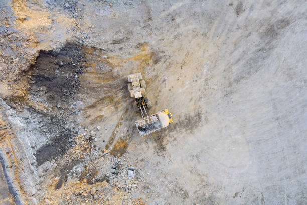 istock Excavator at work with loading of stone into truck 1375346674
