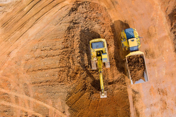 istock Aerial view on excavators work on construction site dumping earth for loading onto dump trucks 1375346676