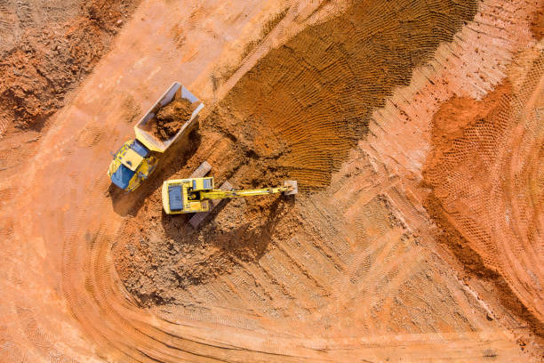 istock Bulldozer is scraping a layer of soil and excavator is digging and dumping earth for loading onto dump truck 1375346679