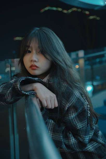 istock Asian young women on the bridge at night 1375349905