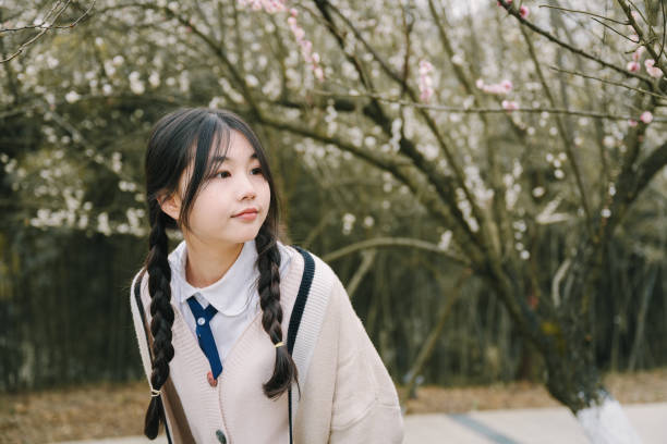 istock Beautiful asian girls under cherry trees 1375357285