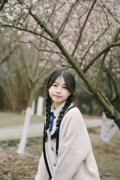 istock Beautiful asian girls under cherry trees 1375357805