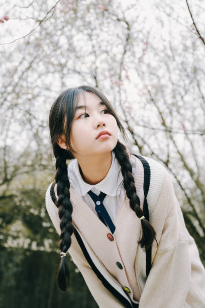 istock Beautiful asian girls under cherry trees 1375357807