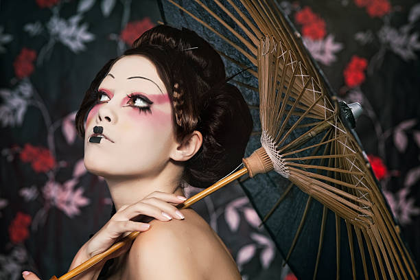 portrait of a beautiful white girl in geisha style stylized picture of a Japanese geisha, make-up done by professional Polish artist modern geisha stock pictures, royalty-free photos & images