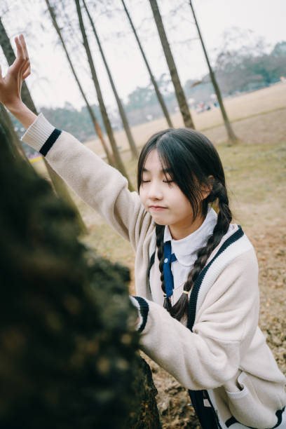 istock Happy Asian girl by the tree 1375370860
