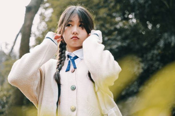 Beautiful asian girls make faces in the sun