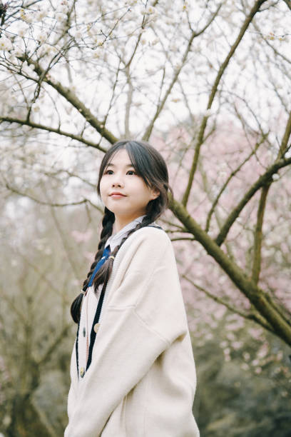 istock Beautiful asian girls under cherry trees 1375377713