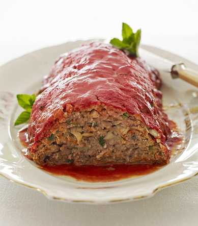 Meat loaf covered with red bell peppers