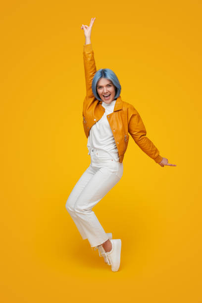 istock Cool hipster standing on tiptoes in studio 1375438976