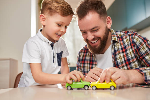 istock Cheerful father and son playing with cars 1375439357