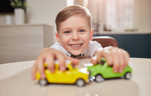 istock Cheerful boy playing with toy cars 1375439365
