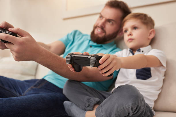 istock Father and son playing videogame 1375439408