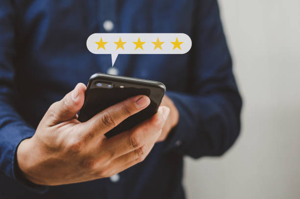 Customer service concept excellent service for satisfaction five star rating with business man holding smart phone. stock photo