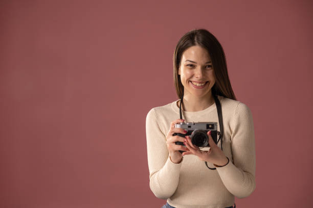 istock Woman with vintage camera 1375447052