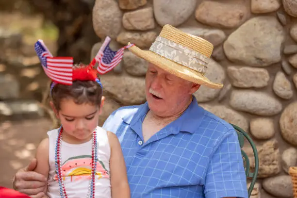 High quality stock photos of a grandfather and granddaughter on a fourth of July celebration.