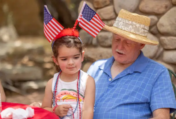 High quality stock photos of a grandfather and granddaughter on a fourth of July celebration.