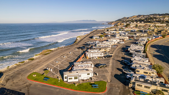 Aerial stock photo of a recreational vehicle park in Pacifica, California jutting along the coast.