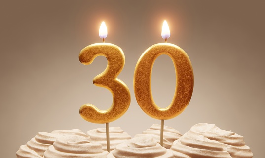 30th birthday or anniversary celebration. Lit golden number candles on cake with icing in neutral tones. 3D rendering