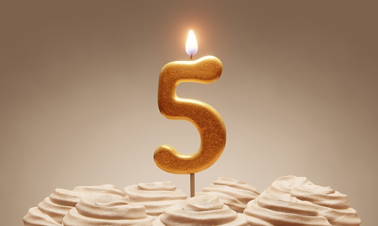 5th birthday or anniversary celebration. Lit golden number candle on cake with icing in neutral tones. 3D rendering