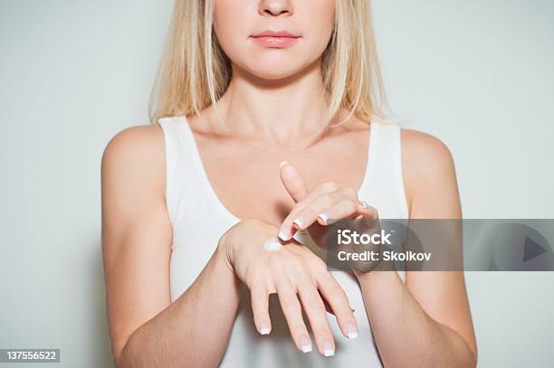 Young Beautiful Woman Applying Moisturizing Cream To Her Hands Stock Photo - Download Image Now