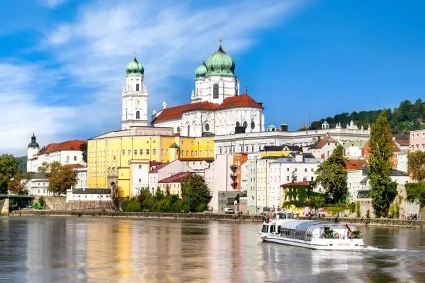 View of St. Stephen's Cathedral with tour ship on the Danube in Passau, Bavaria, Germany