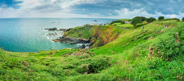 The Lizard Peninsular,Southern Cornwall,England-July 24th 2021:Tourists gather on the distant Lizard,Britain's southernmost promontory, enjoying the fine summer weather,views and refreshments.