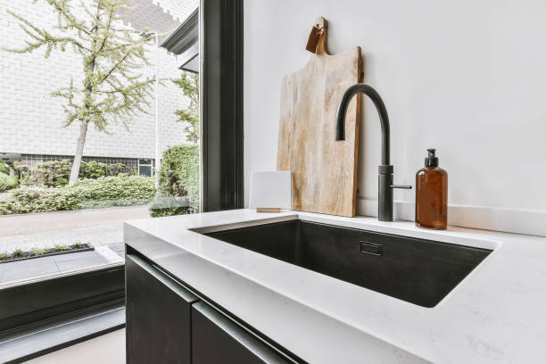 istock Stylish sink built into a white countertop 1375583983